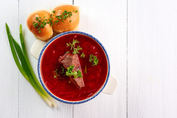borsch with pampushkas, lard and onion at white table top. borsch is traditional ukrainian cuisine red soup with beet, potato, meat, carrot, cabbage and garlic. copy space