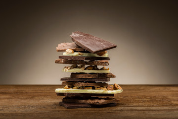 pile of mixed chocolate pieces, on wooden table