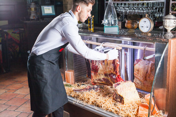 Display of Dry Aged Meat Steaks in butchers shop or restaurant in an display refrigerator.