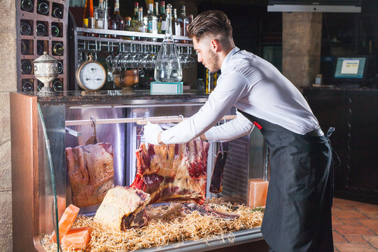 Display Of Dry Aged Meat Steaks In Butchers Shop Or Restaurant In An Display Refrigerator.