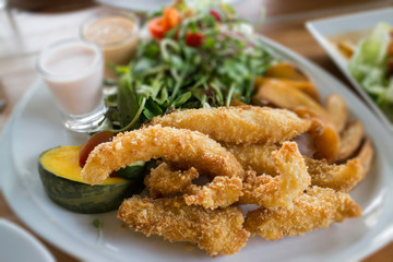 Fried fish and chips serving with vegetable