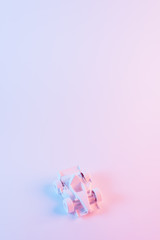 Painted formula one car against pink background with copyspace