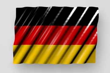 cute shiny flag of Germany with big folds lying flat isolated on grey - any celebration flag 3d illustration..