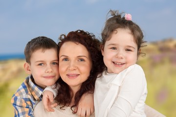 Parents Giving Children Piggybacks In Countryside
