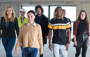 young multiethnic business people walking through unfinished startup office