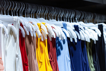 Fototapeta premium Buying casual clothes on second hand market in store. Shopping in fashion mall, choosing new clothes
