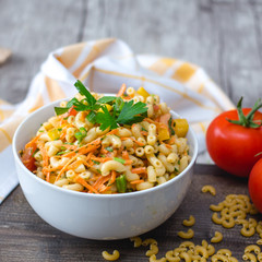 Pasta Salad with vegetable in a white bowl 