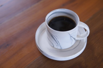 cup of coffee on wooden table