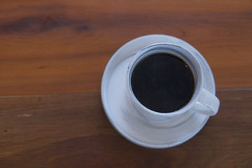 cup of coffee on wooden table