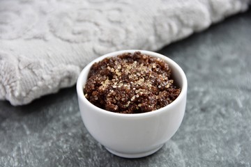 Natural, homemade coffee, brown sugar and honey lip scrub in small bowl.