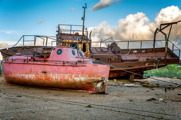 Old rusty abandoned ship on the shore. Gloomy northern nature.