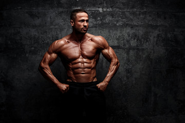Fototapeta na wymiar Power! Strong Muscular Men posing and Flexing Muscles