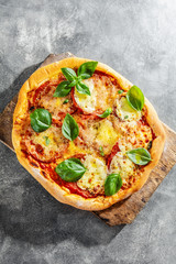 Homemade pizza with mozzarella on grey background