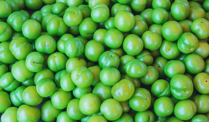 Plum green sold in the market in Georgia. Selective focus.