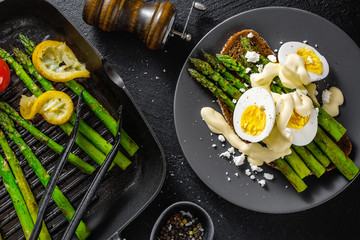 Tasty toasts with asparagus, eggs and sauce