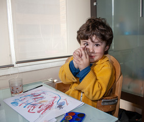 NIño jugando pintando en la mesa