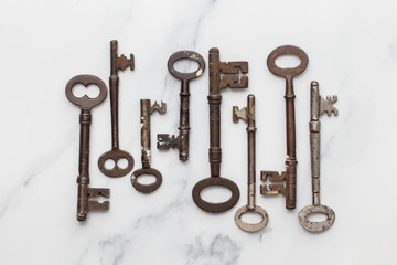 Vintage old fashioned keys on a marble background