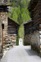 narrow road between historic wooden houses in Ticino Canton