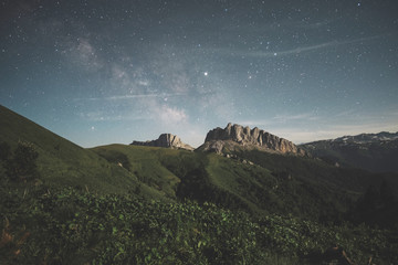 mountain range against the night starry sky and the milky way