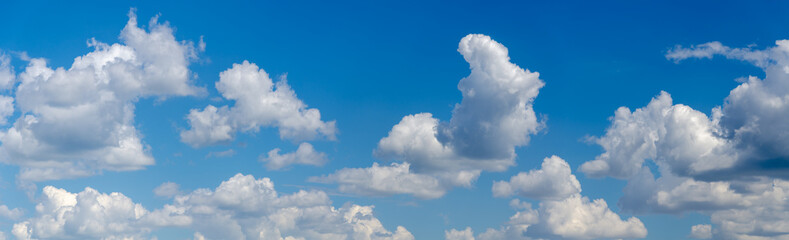 Naklejka na ściany i meble Panorama of blue sky with white cumulus clouds