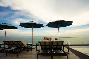 Couples sitting together by the swimming pool. Vacation and relaxation concepts.