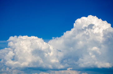 Naklejka na ściany i meble Blue sky background with white cumulus clouds