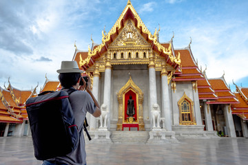 Eastern Asia summer holidays. Asian man tourist taking photos with cameras at Wat Benchamabopitr...