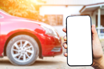 Close-up of female use Hand holding smartphone blurred images touch of Abstract blur of headlight ,window of red car outdoor background.