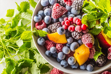 Frozen fruits blueberries blackberry raspberry red currant peach and herbs melissa