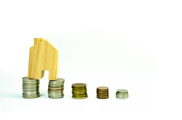 House model on coin pile saving for concept with isolated on white background.Concept for property ladder, mortgage and real estate investment. investment mortgage fund finance and home loan.