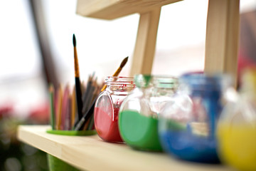 pencil in basket with liquid paint on wooden table