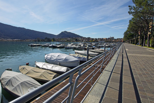 Lake Iseo near Sarnico, Italy boats moored against ier.