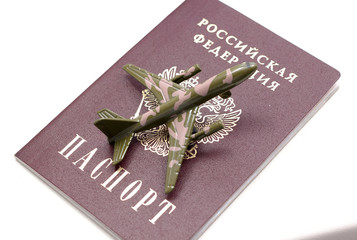 Passport, airplane on a white background. Travel concept, copy space. Airplane, passport in female hand on a white background. Soft focus.