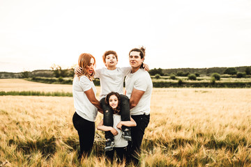 Portrait of a happy and beautiful family playing in the countryside. Family having fun