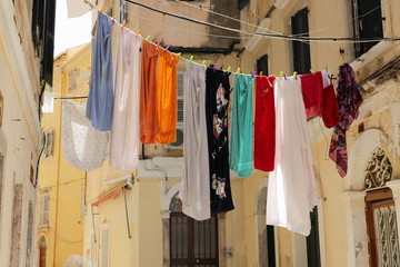 Hanging laundry on a narrow street in Corfu Greece