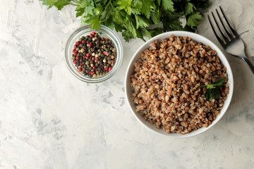 Buckwheat. Porridge cereals in a glass plate on a bright table. breakfast, healthy food. top view