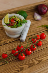 guacamole and fresh vegetables on wooden table