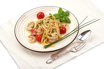 Italian Spaghetti with shrimp, shellfish and cream sauce, restaurant dish, close-up, isolated on white background