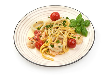Italian Spaghetti with shrimp, shellfish and cream sauce, restaurant dish, close-up, isolated on white background