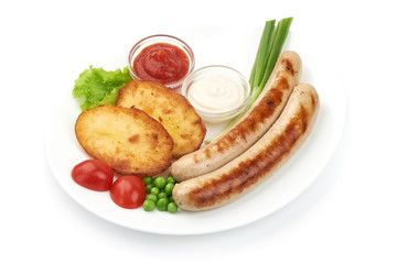 Grilled Thuringer Rostbratwurst sausages with baked potatoes, close-up, isolated on white background