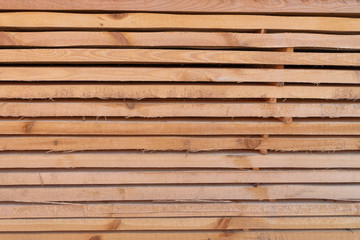 Fototapeta premium Construction boards, strap, folded into a neat pack on a construction site. Creative vintage background.