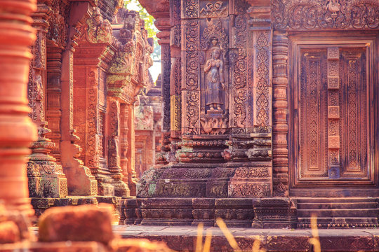 Celestial maiden carved into the red sandstone walls, Banteay Srei temple, Angkor, Cambodia.