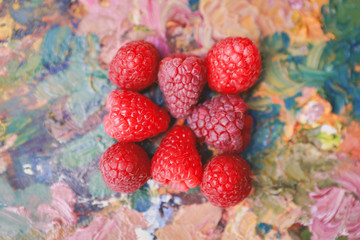 fresh delicious raspberry on a palette of colors
