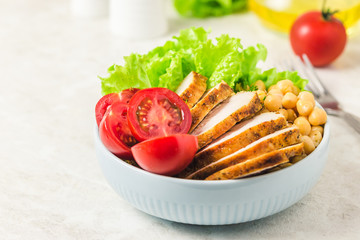 Chicken chickpea vegetable lunch bowl. Selective focus, space for text.