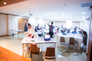 blurry image. speaker or lecturer with laptop and projector for presenting to business team brainstorming on meeting workshop.