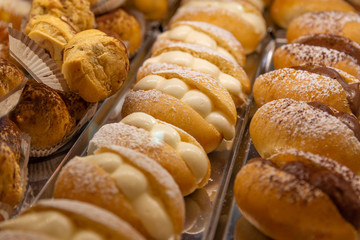 Italian sicilian pastries with chocolate and white cream.
