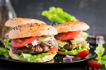 Big sandwich - hamburger burger with beef,  tomato,  red onion and lettuce.