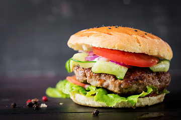 Big sandwich - hamburger burger with beef,  tomato,  red onion and lettuce.