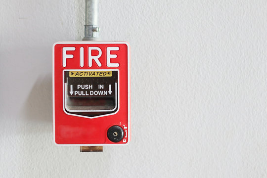 Fire alarm switch on the wall in factory.