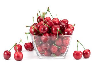 Sweet cherry in a glass plate on a white background.